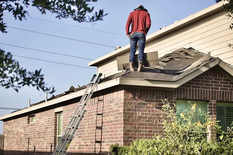 Professional roofer working on a residential roof in Belvidere